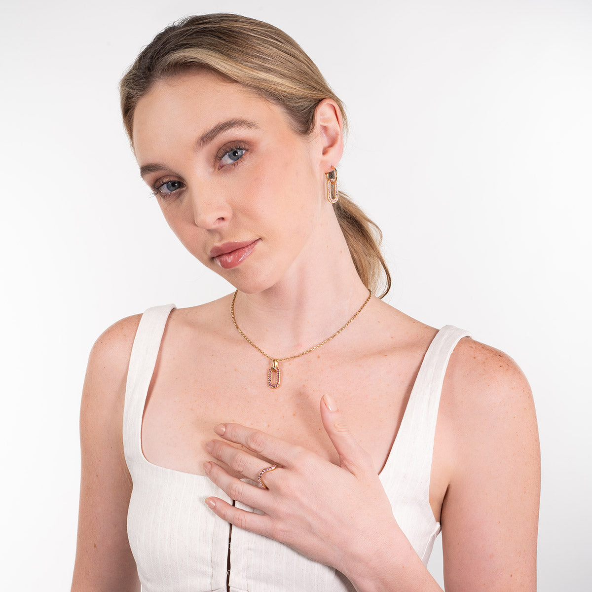 Anillo en baño de oro diseño ondulado con piedras rosa brillante