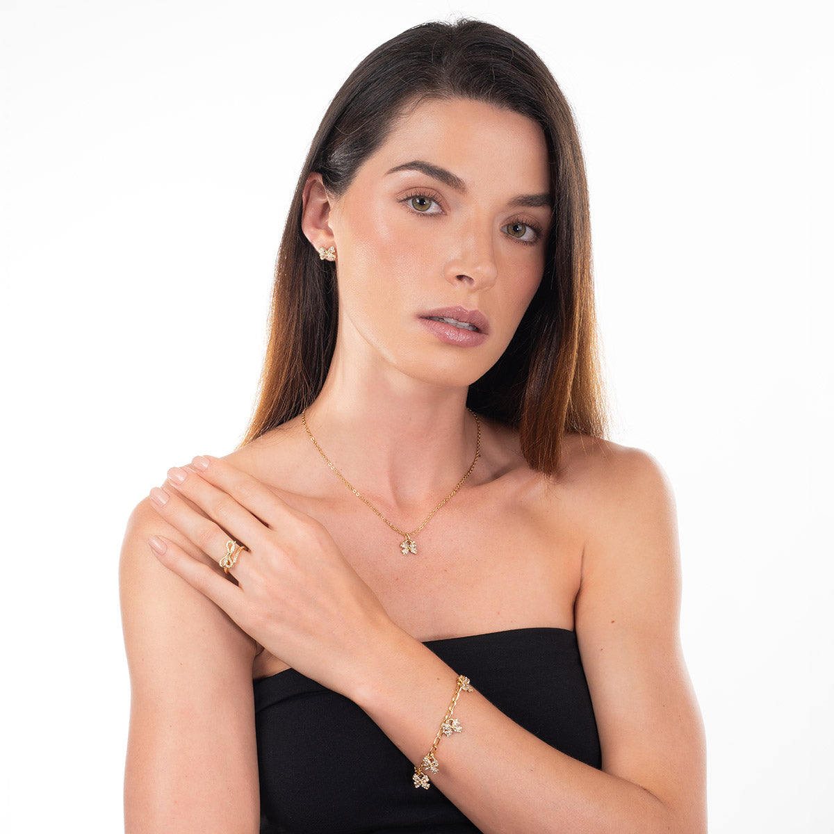 Aretes de moño con baño de oro y cristales